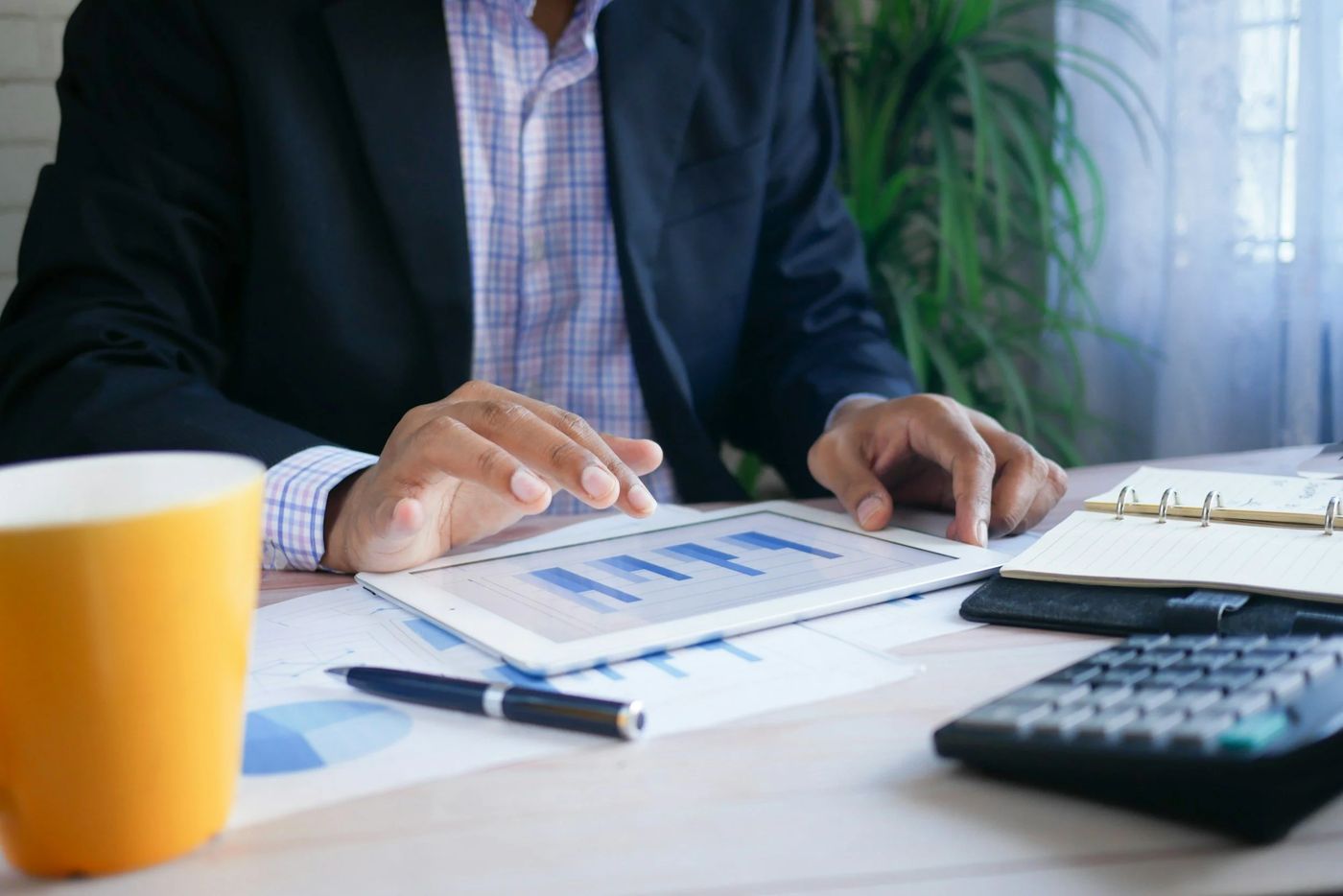 Business owner reviewing financial charts on a tablet